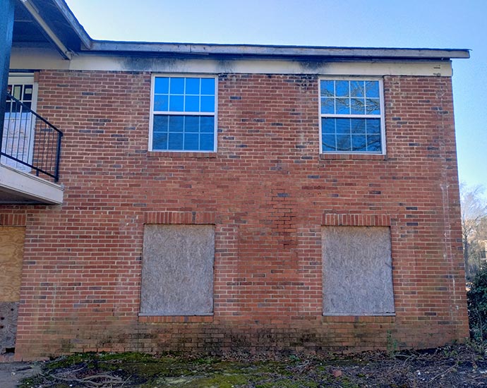 Brick building with boarded-up windows