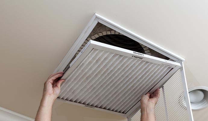 Person replacing air filter