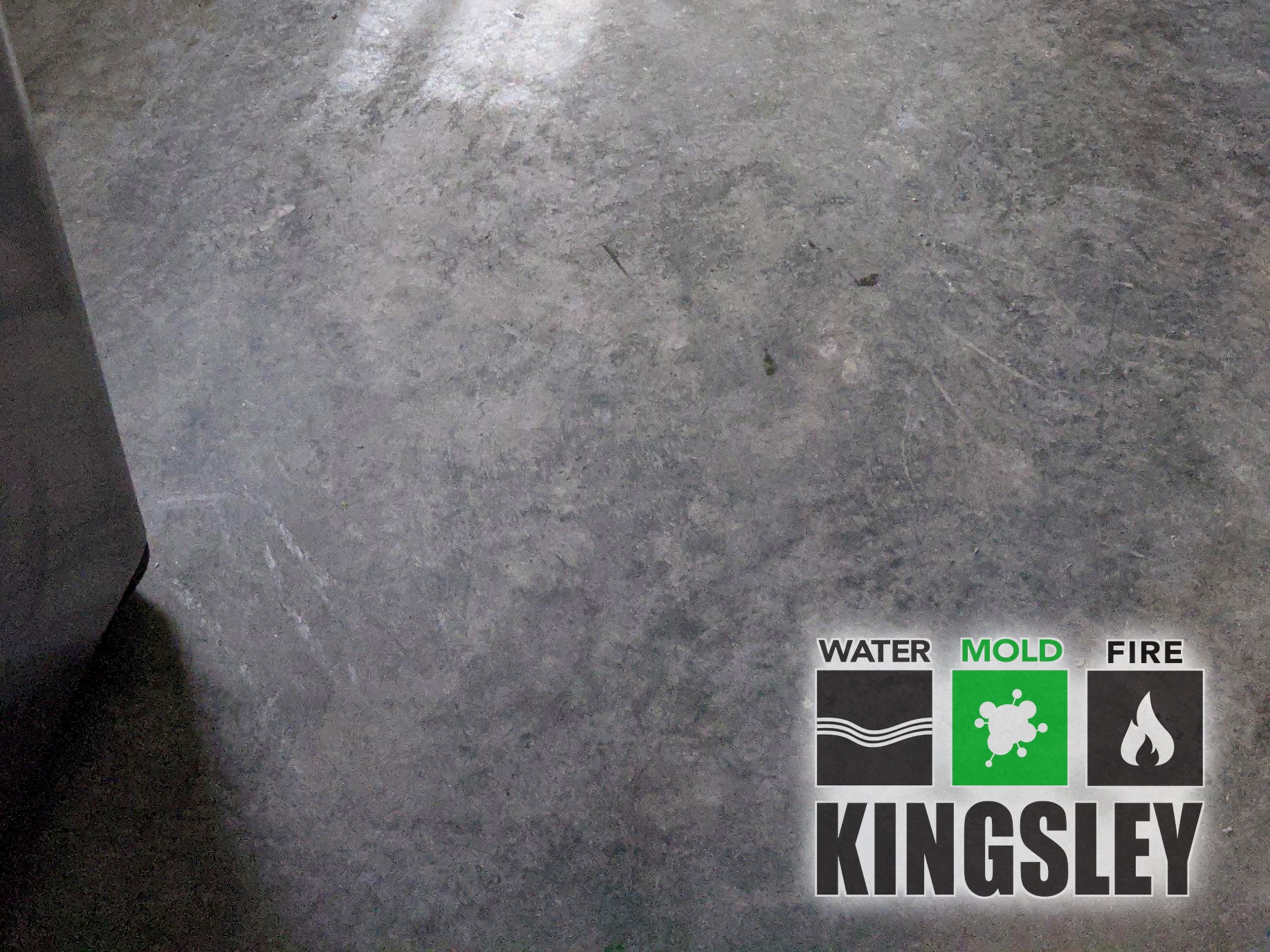 Disconnected dishwasher pulled into kitchen center with flood-cut drywall and exposed PVC drain during Kingsley water cleanup in Irmo, SC